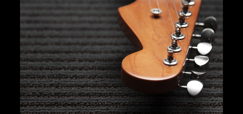 Guitar display in musical instruments store - Seven Plus UAE
